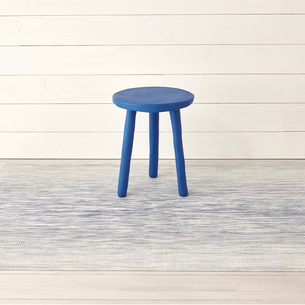 Wave / Blue woven floor mat by Chilewich, interior setting