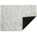 Mosaic / White/Black woven floor mat by Chilewich, folded-corner studio view