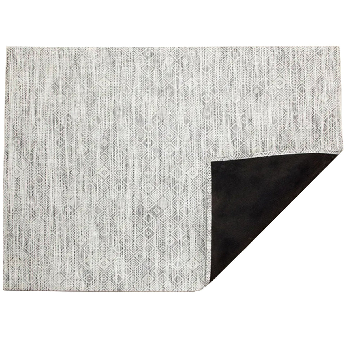 Mosaic / White/Black woven floor mat by Chilewich, folded-corner studio view