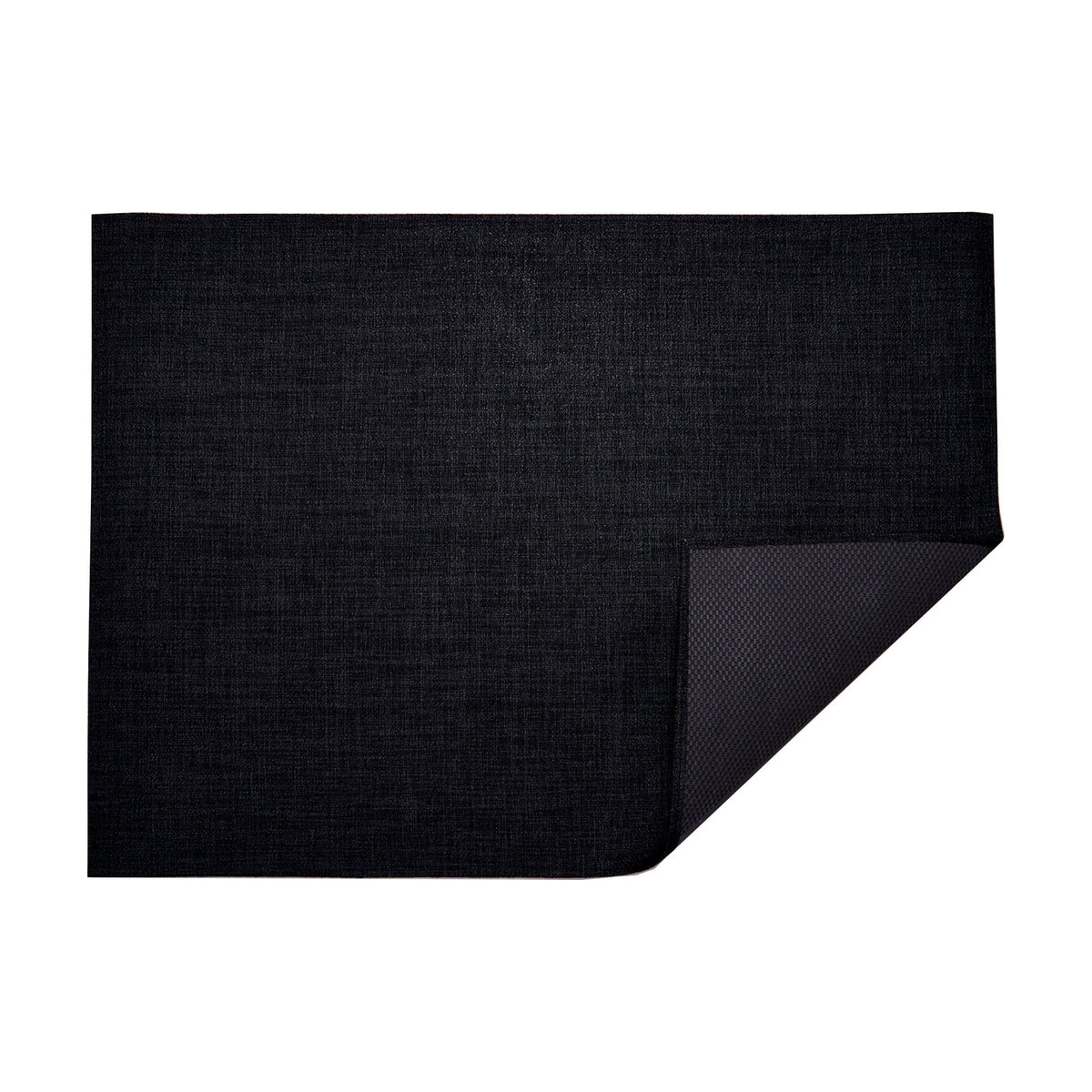 Bouclé / Noir woven floor mat by Chilewich, folded-corner studio view