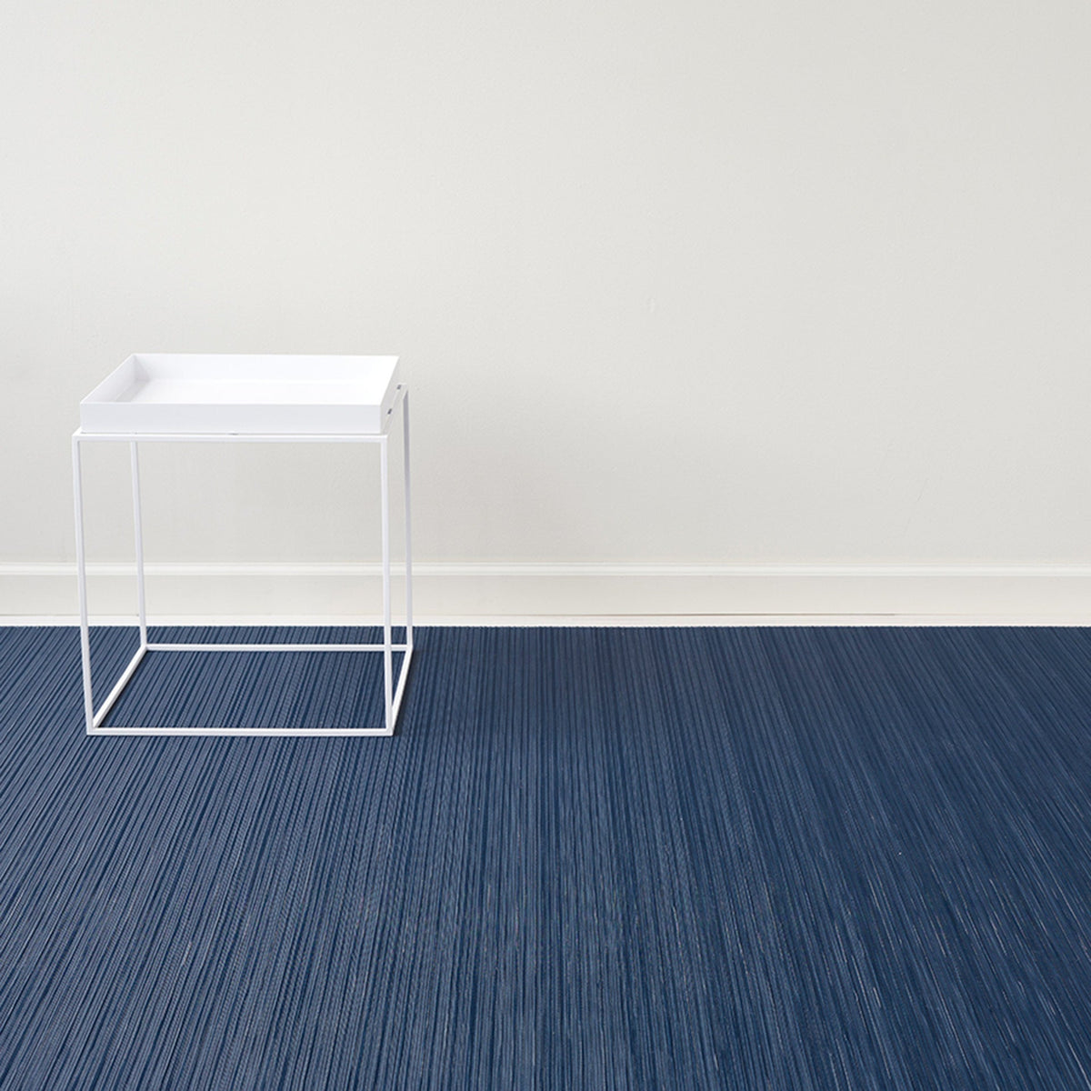 Rib Weave / Indigo woven floor mat by Chilewich, interior setting