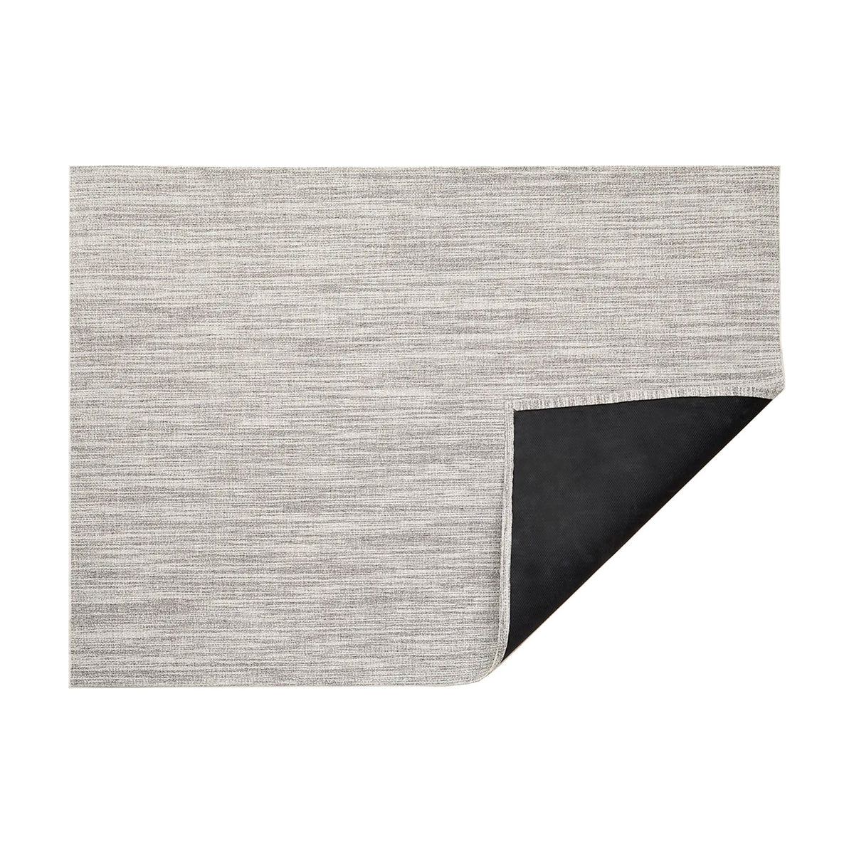 Bouclé / Salt woven floor mat by Chilewich, folded-corner studio view