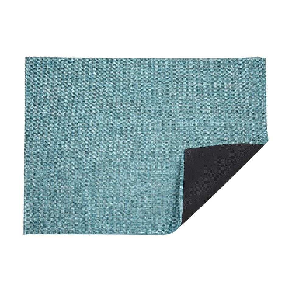 Mini Basketweave / Turquoise woven floor mat by Chilewich, folded-corner studio view