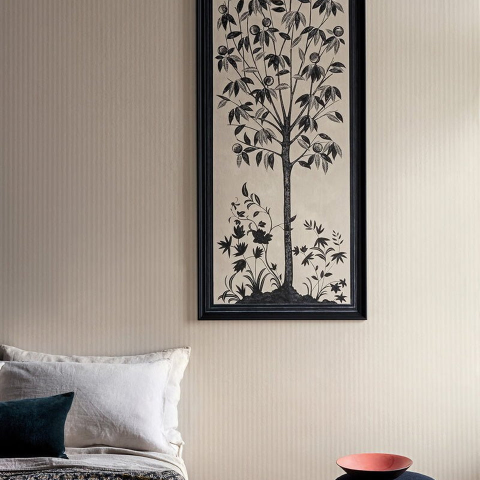 Eden Stripe in Parchment on a wall with a framed botanical panel