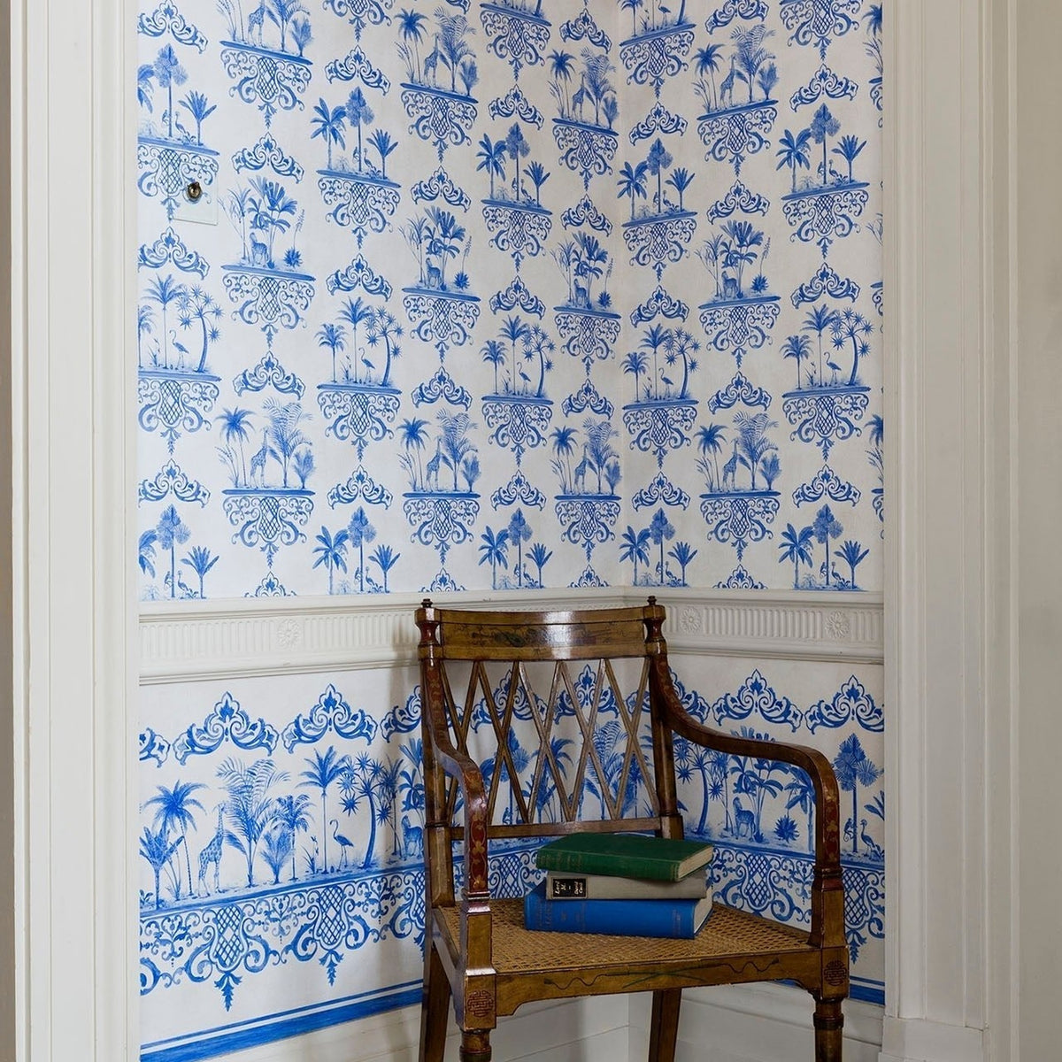 Rousseau Border by Cole & Son in Blue on White, room setting with coordinating Rousseau wallpaper