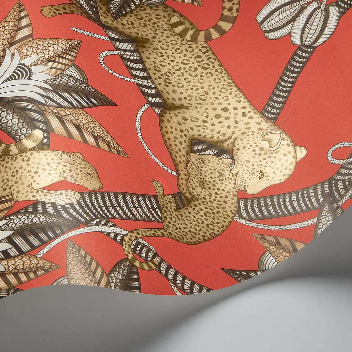 Satara wallpaper by Cole & Son in Soot & Metallic Gold on Rouge, curved paper detail