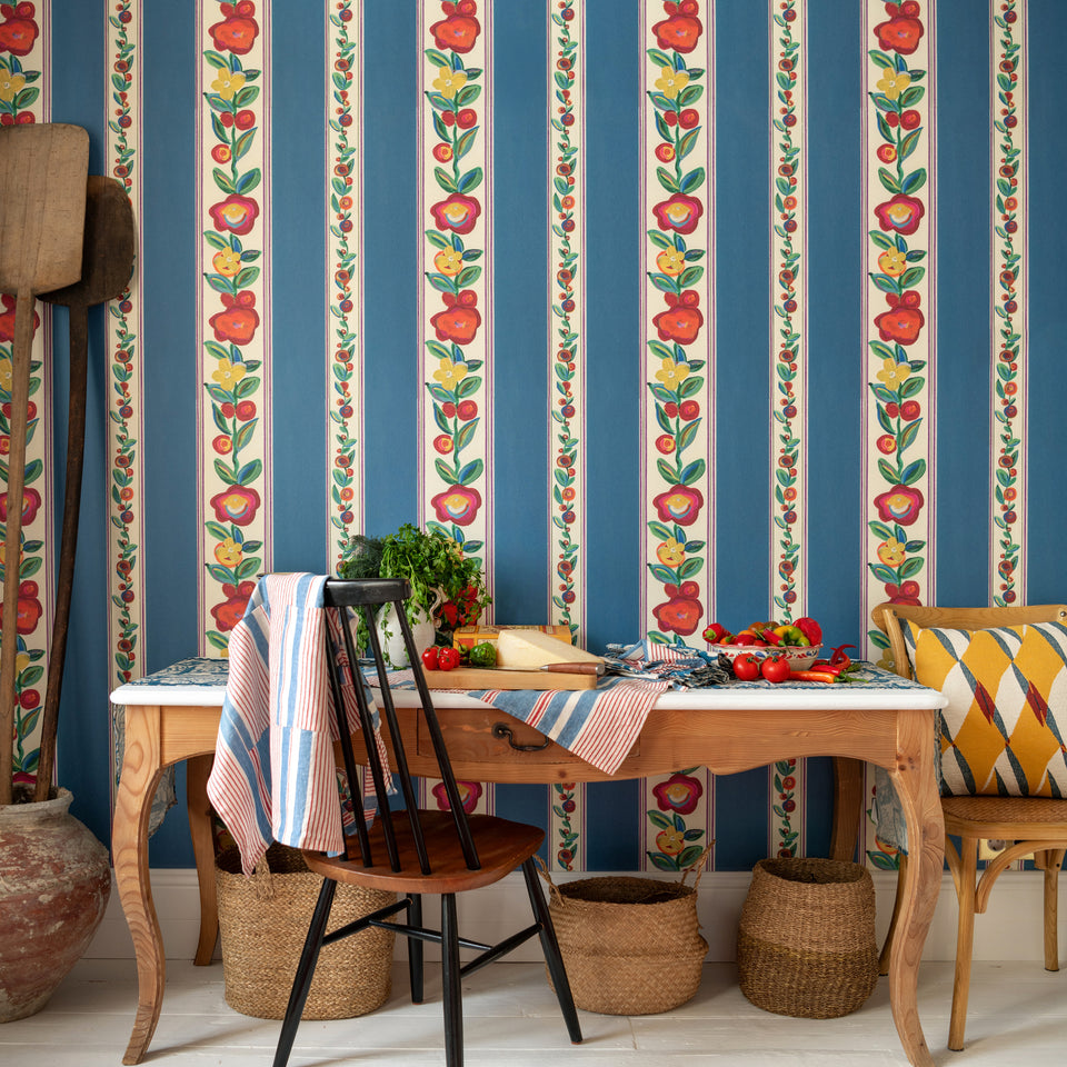 Dainty Flowering Azure wallpaper by MINDTHEGAP, shown in a furnished interior.
