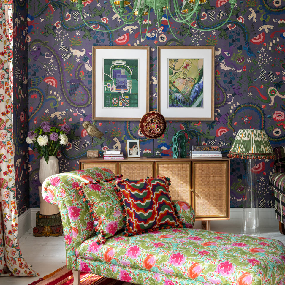 Dragon Flower Purple wallpaper by MINDTHEGAP, shown in a furnished interior.