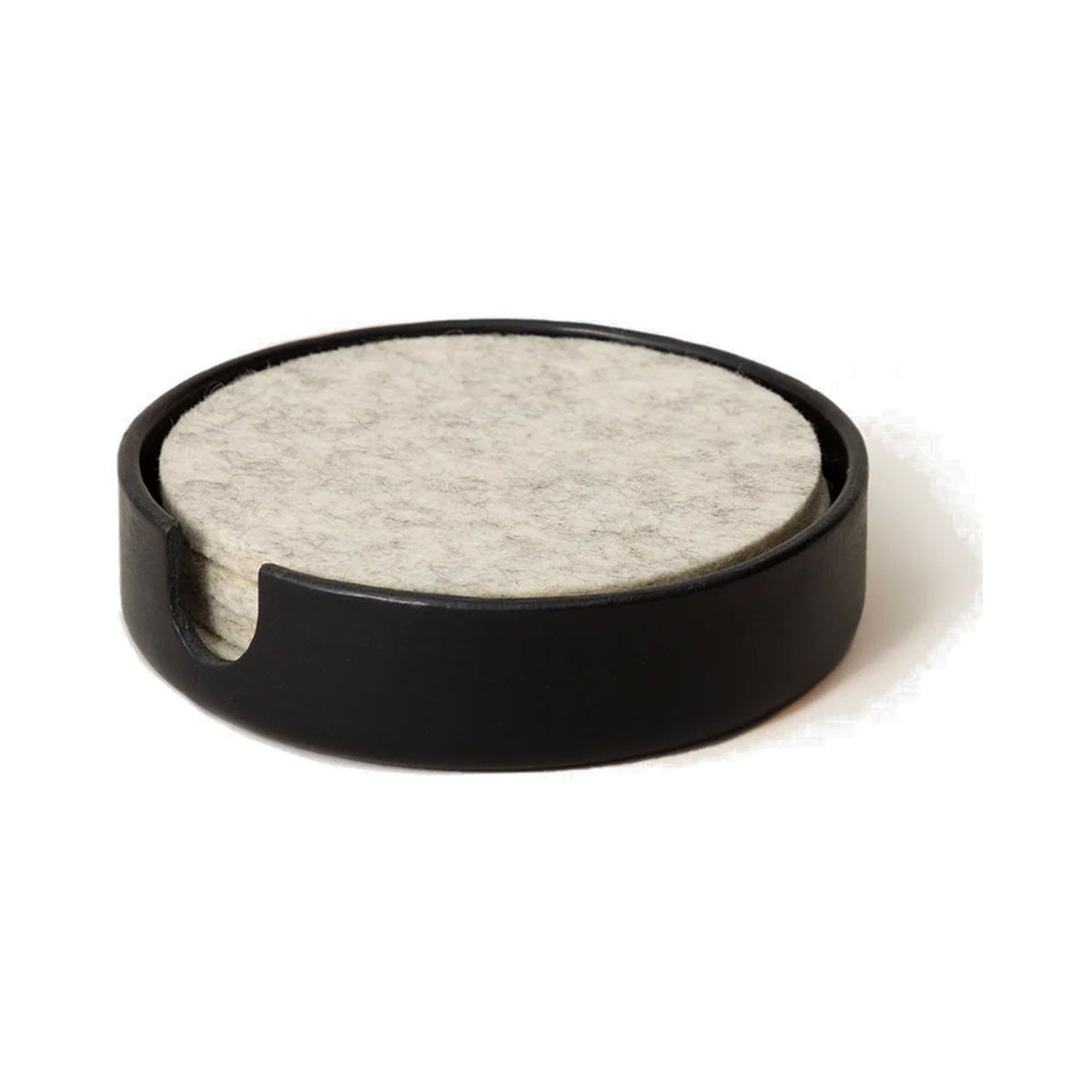 Graf Lantz Black Kobon round leather tray holding a stack of light felt coasters