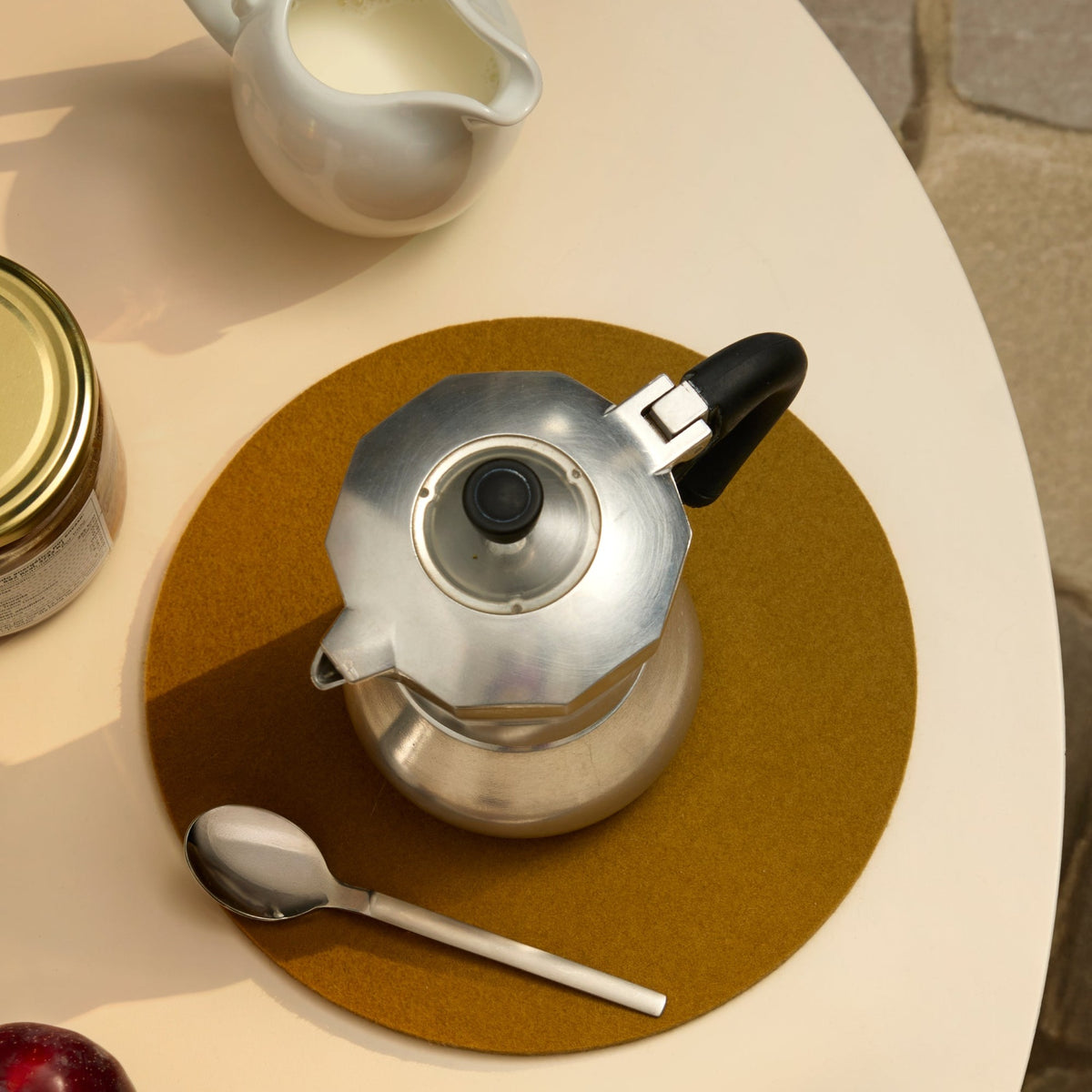 Graf Lantz Brine round felt trivet beneath a moka pot on a breakfast table