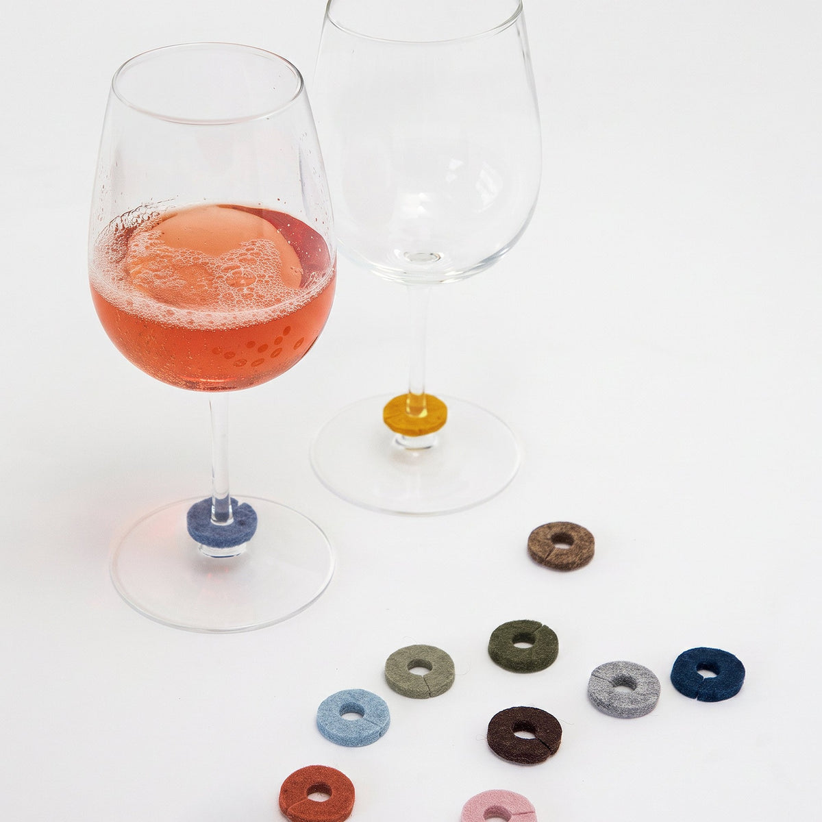 Graf Lantz Ikebana felt wine markers arranged beside two wine glasses