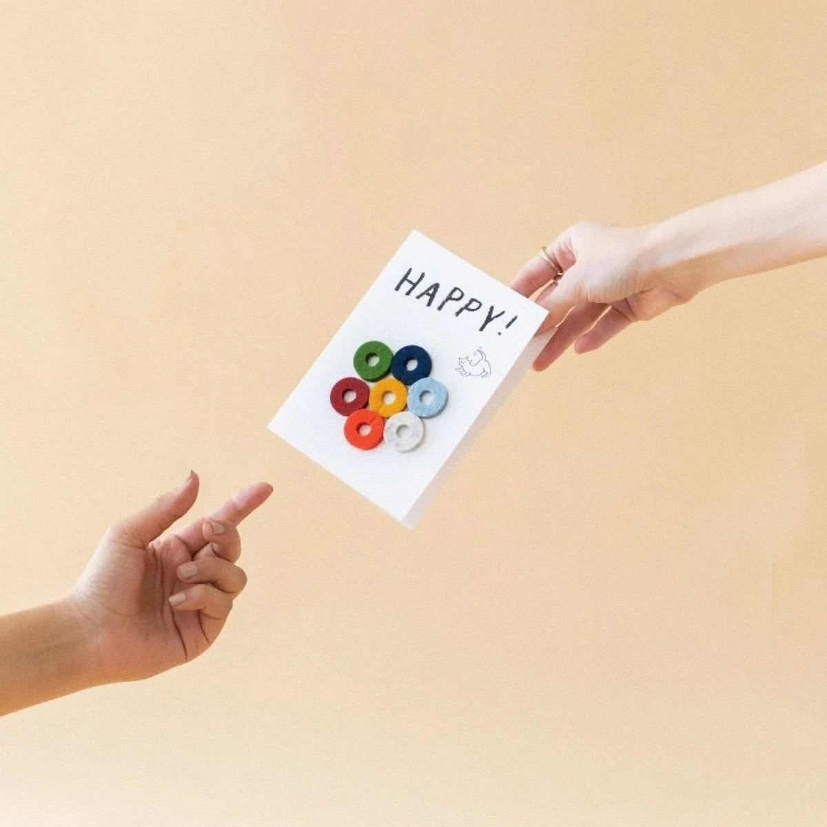 Graf Lantz Hands exchanging a Happy Wine-Ote’s felt wine marker card