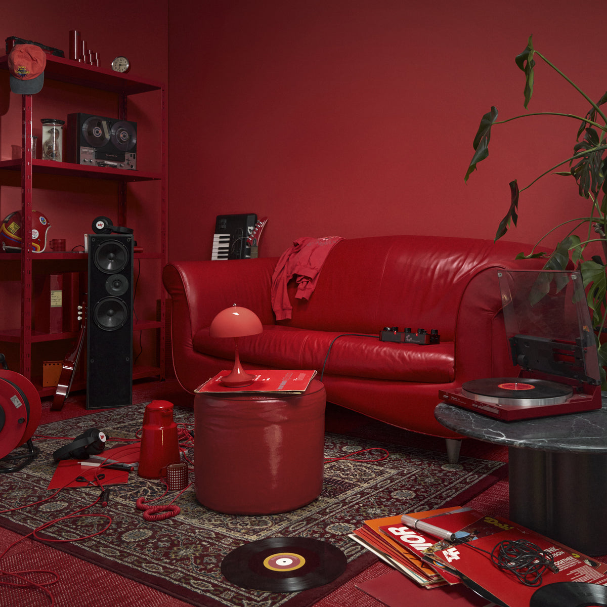Opaque Coral Panthella 160 Portable lamp in a red living room.