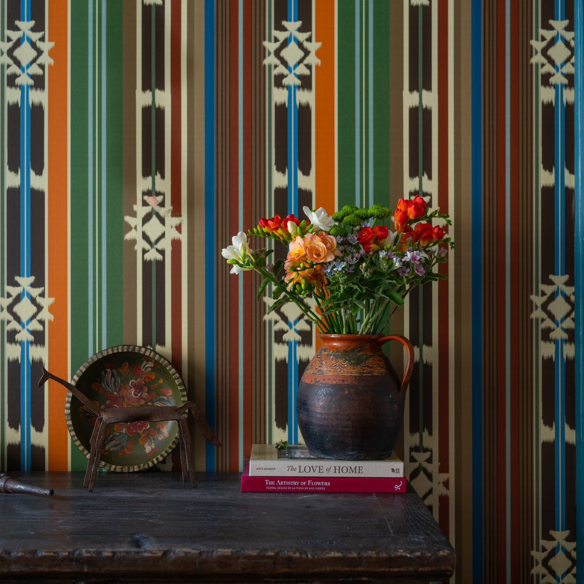 Mistletoe Poly wallpaper by MINDTHEGAP, close-up in a styled interior.