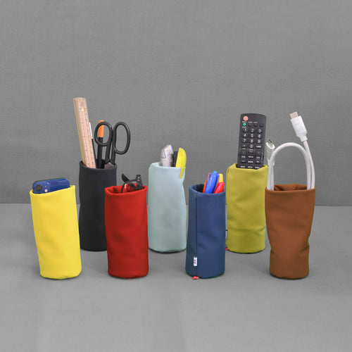 Tat-Tat Sacco storage pouches holding glasses, desk tools and everyday accessories