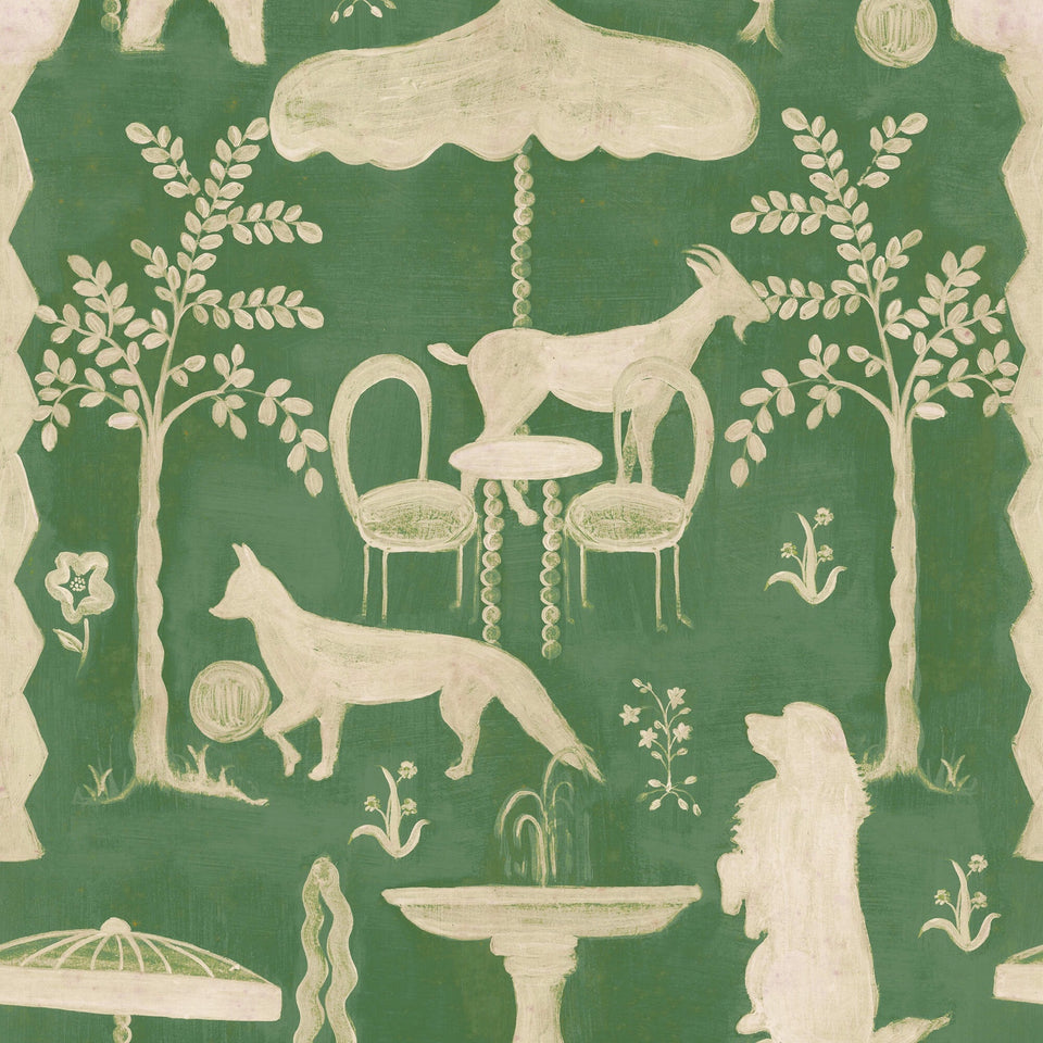 The Hidden Realm Emerald wallpaper by MINDTHEGAP, featuring cream animal figures, trees, and a fringed parasol on a deep emerald green background.