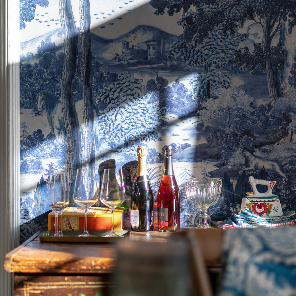 Toile Du Carpathians Indigo wallpaper by MINDTHEGAP, close-up in a styled interior.