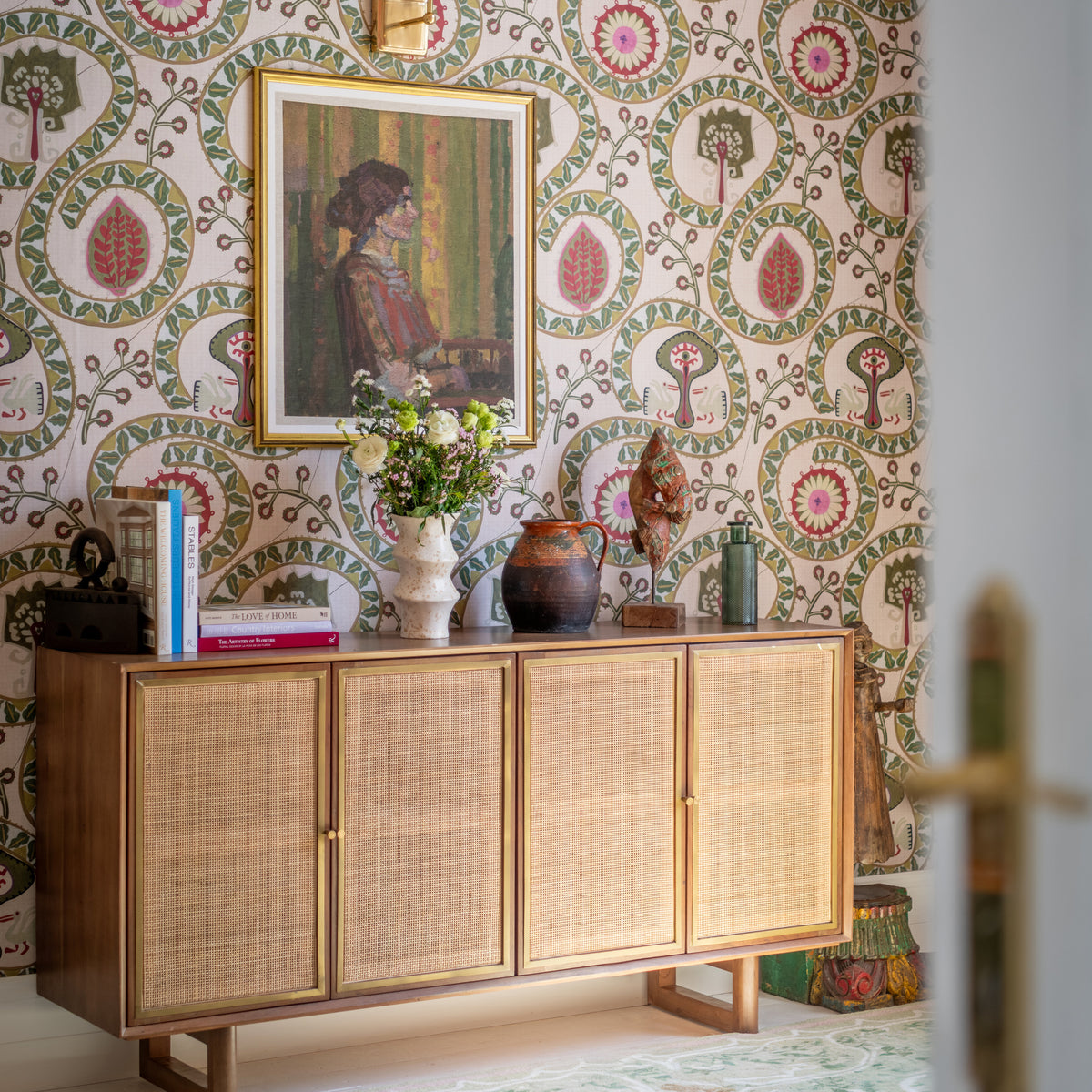 Two Storks Taupe wallpaper by MINDTHEGAP, shown in a furnished interior.