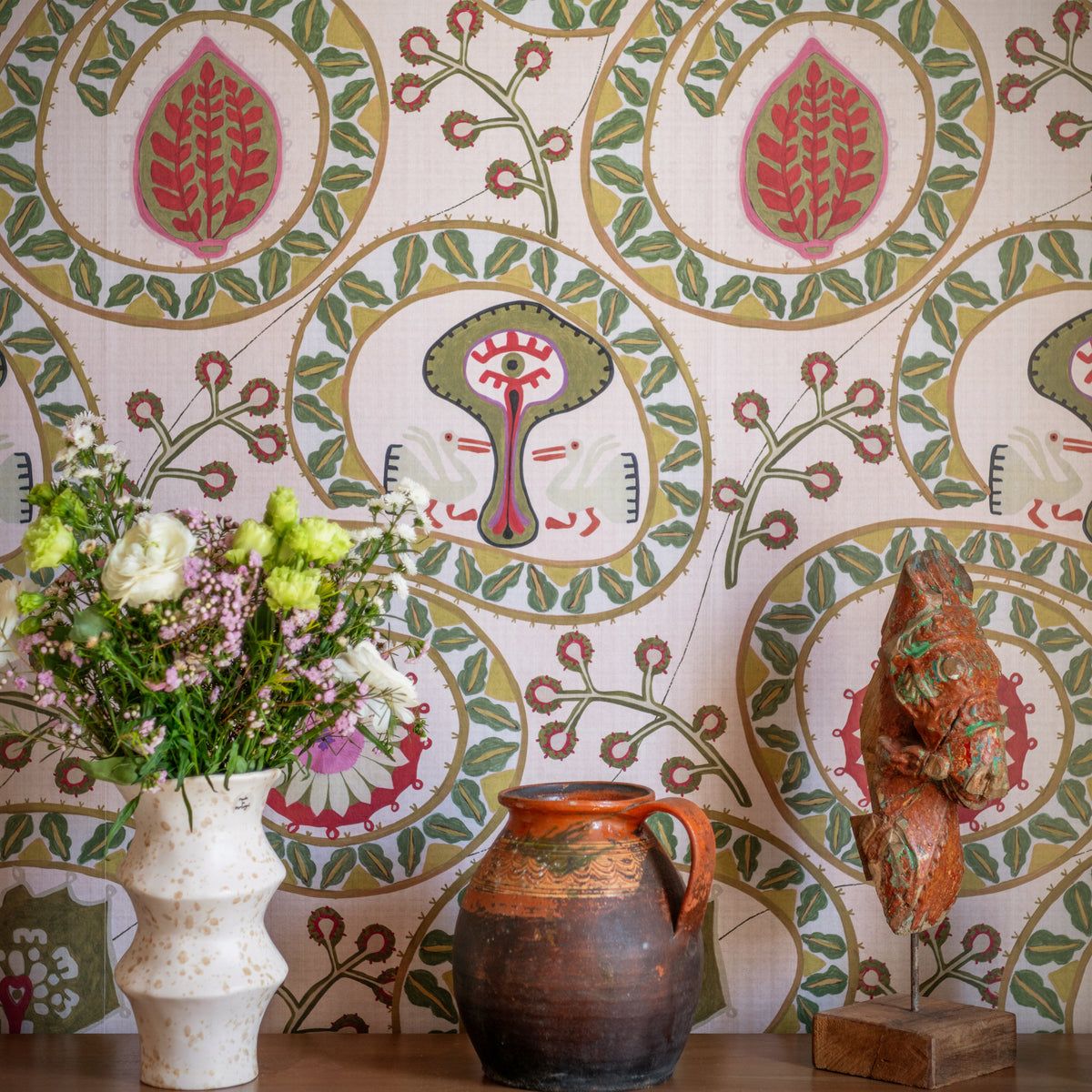 Two Storks Taupe wallpaper by MINDTHEGAP, close-up in a styled interior.