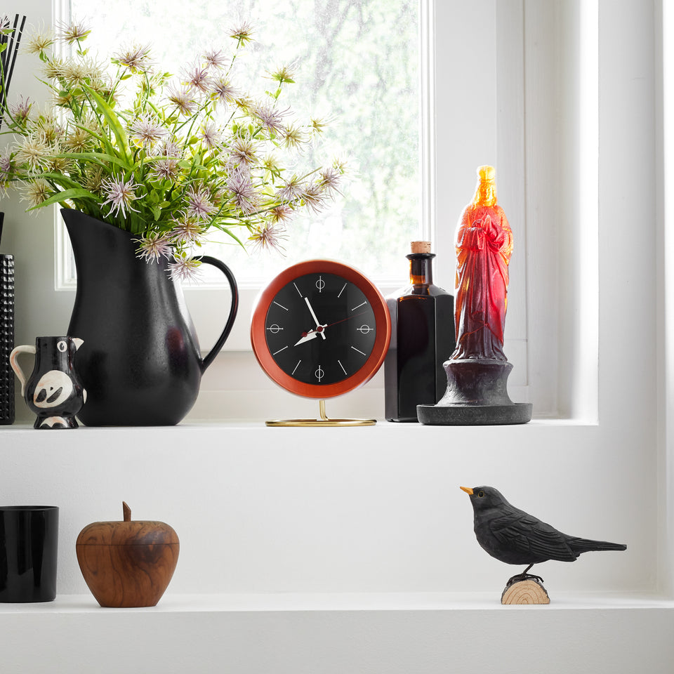 George Nelson Chronopak Desk Clock displayed on a shelf with books and objects