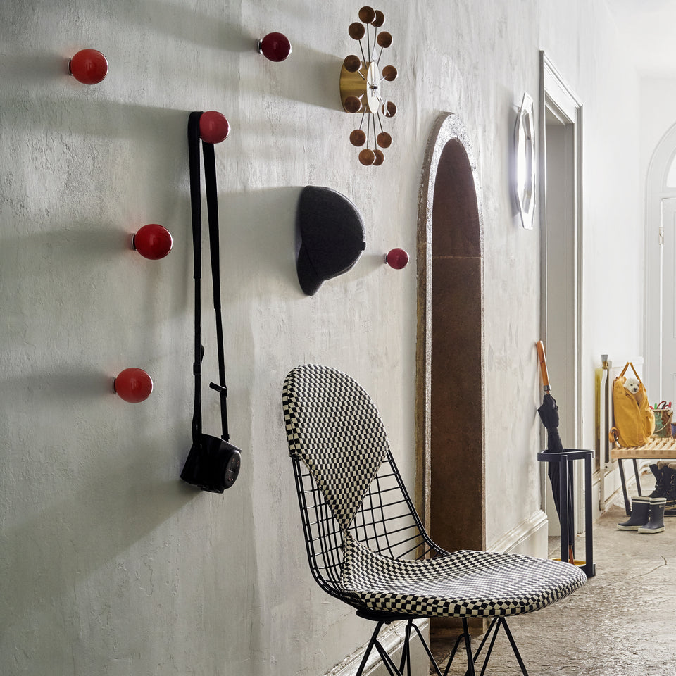 Red Vitra Coat Dots used as wall hooks in a hallway