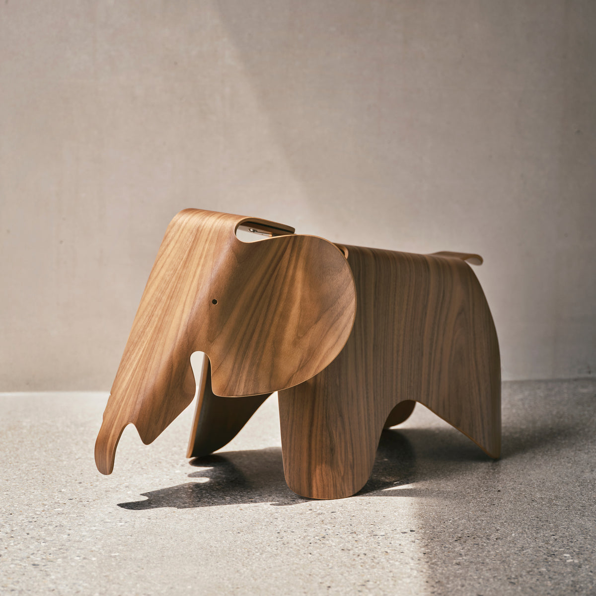 Walnut Eames Plywood Elephant displayed in an interior