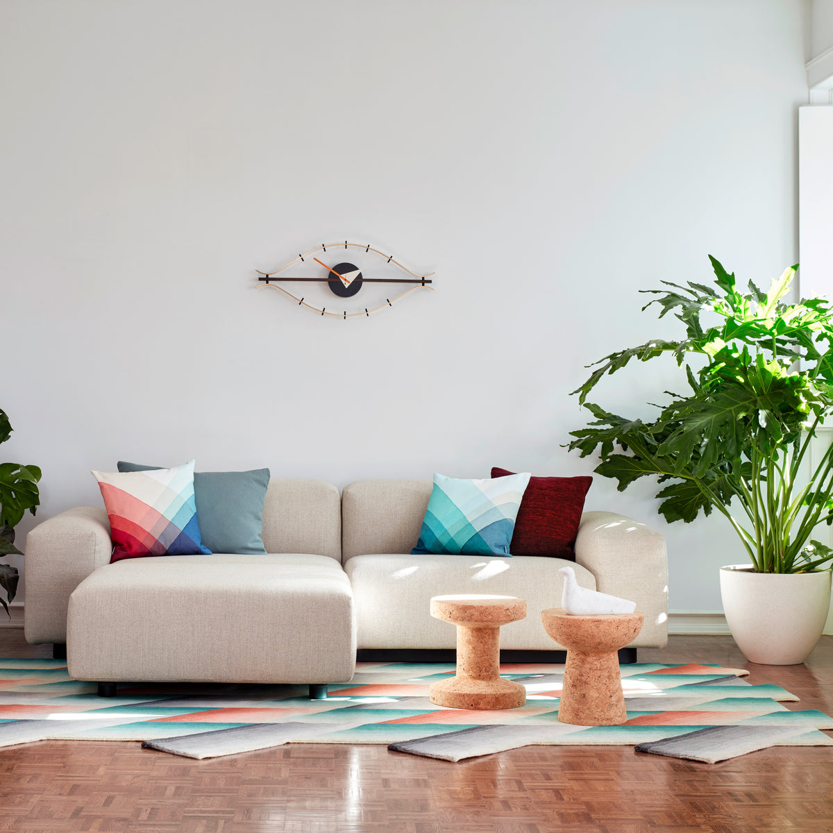 George Nelson Eye Clock above a sofa in a bright living room