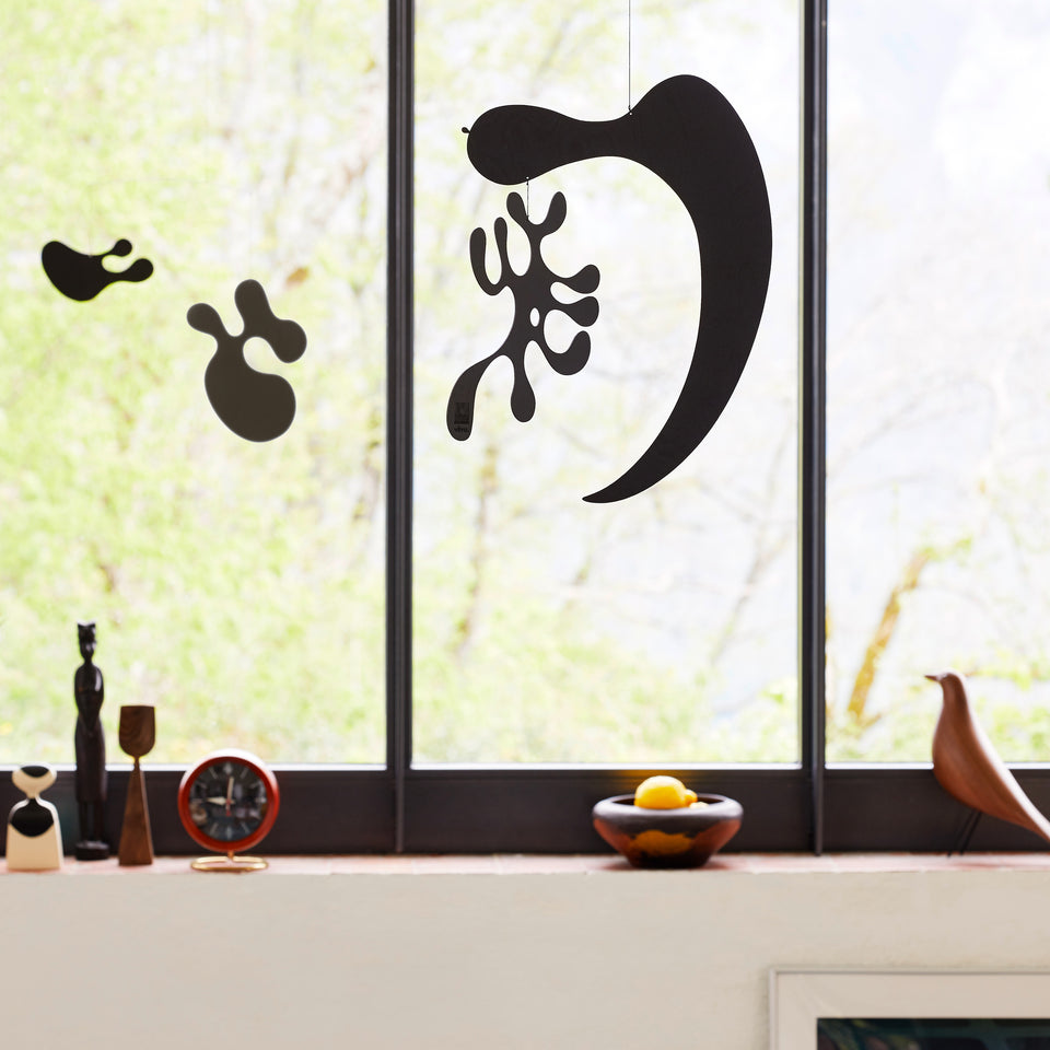 Vitra Plywood Mobiles hanging by a window; models sold individually