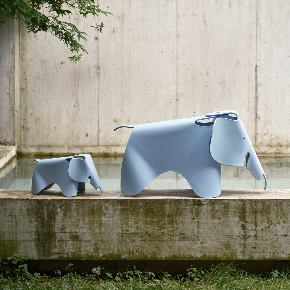 Small Eames Elephant beside the larger model in a courtyard; sizes sold separately
