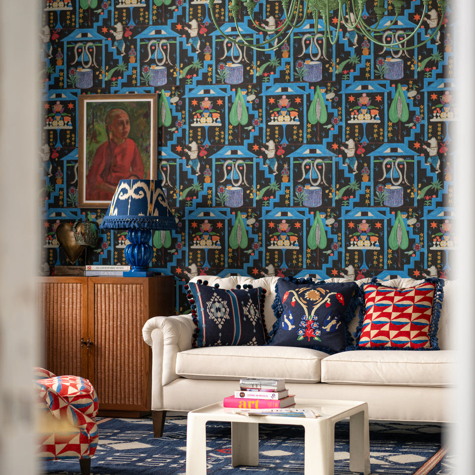 Wonderland Anthracite wallpaper by MINDTHEGAP, shown in a furnished interior.